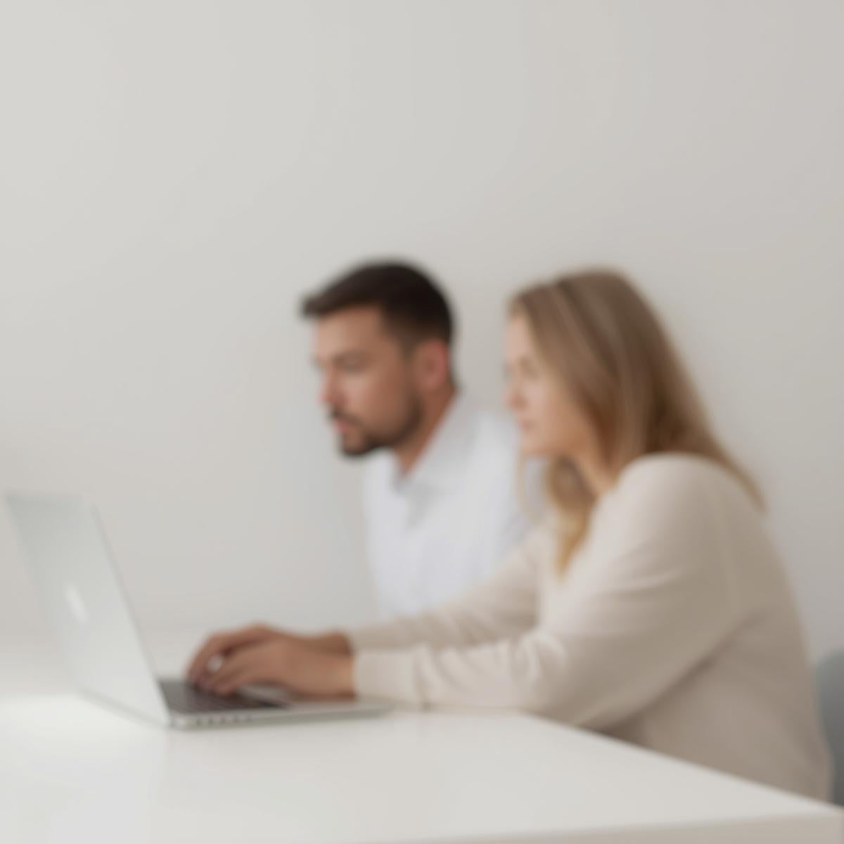 man_and_woman_having_blur_faces_working_on_a_laptop